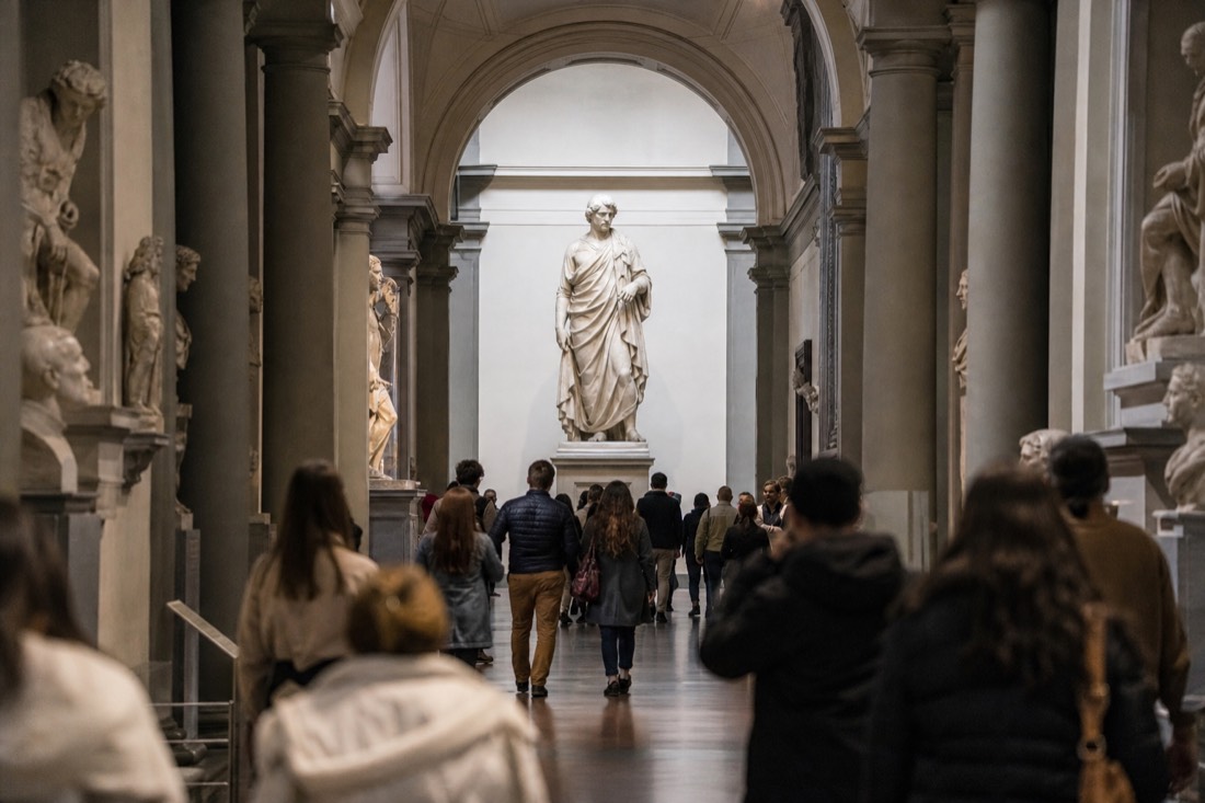 Michelangelo's David under the skylight at the end of the Accademia Gallery corridor in Florence