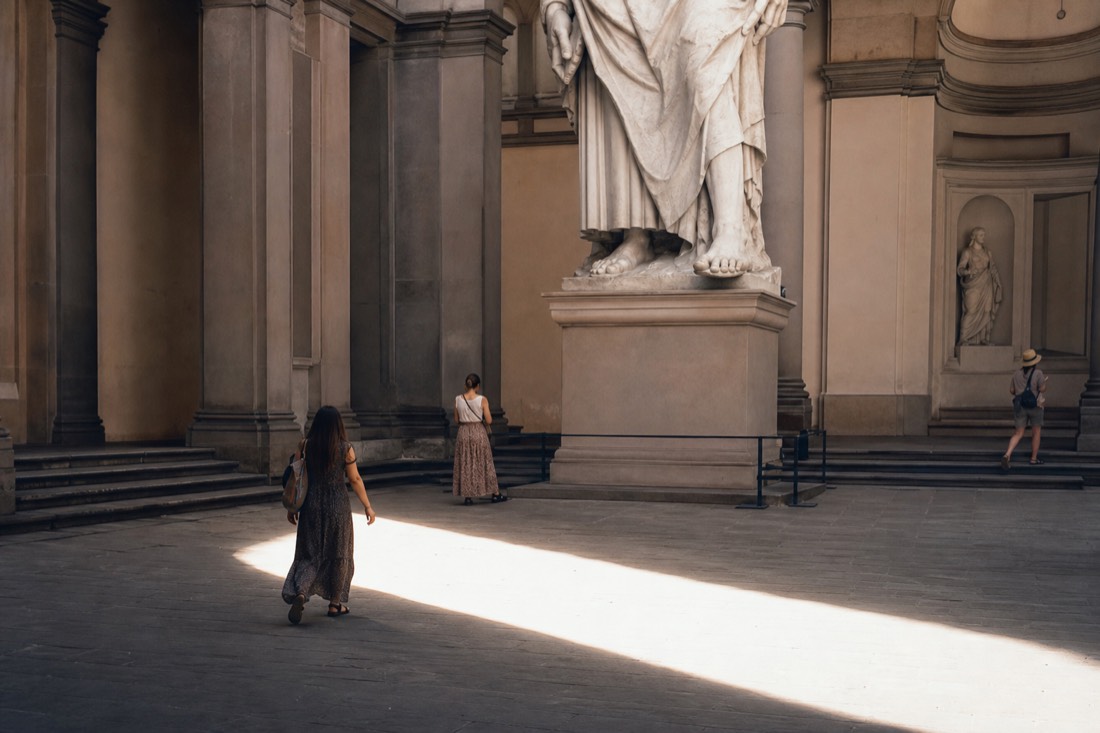 Early morning light falling through the skylight onto an almost empty floor in front of David at the Accademia Gallery in Florence