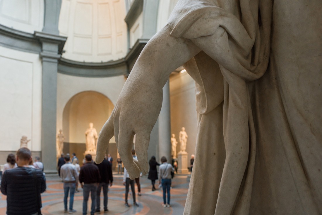 Close view of the marble right hand and forearm of David lit by the natural skylight in the Accademia Gallery tribune in Florence